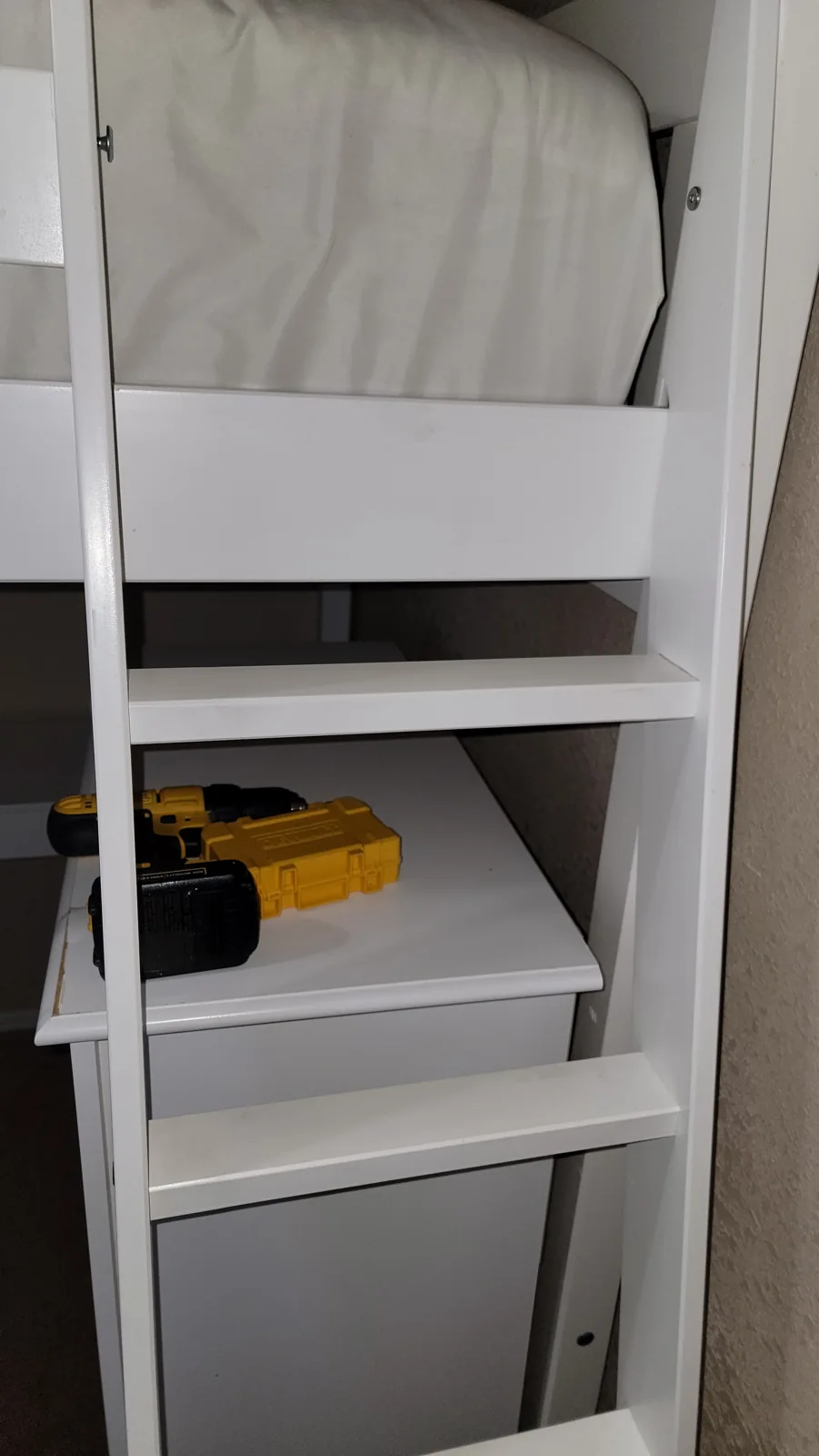 Double bunk bed assembly: ladder and storage detail